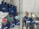 a lot of watches on display in a glass case