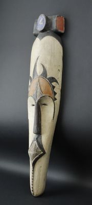 an image of a wooden sculpture of a man ' s face