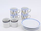 a white table with blue and white plates and cups on it