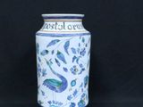a blue and white vase sitting on a black background