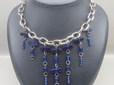 a close up of a necklace on a mannequin with blue beads