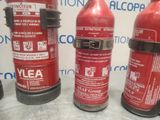 several fire extinguisors are lined up on a table