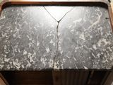 a marble top table with a wooden base and a black and white marble top