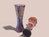 a glass vase and a ring sitting next to each other