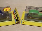 two boxes of toy cars that are on a table
