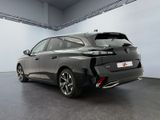 the rear end of a black car in a white room