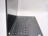 a black laptop with a red button on the keyboard
