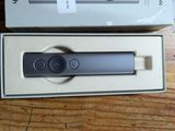 packaging for a new nintendo wii controller sitting on a wooden table