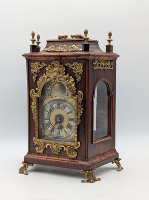 a wooden clock that is sitting on top of a table