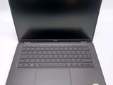 a laptop with a keyboard on it sitting on a table