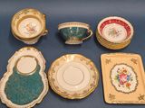 many different types of tea cups and saucers on the table