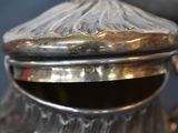 a silver tea pot with a lid on a table