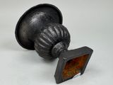 a small metal object with a picture in it