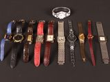 a lot of watches that are lined up on a table