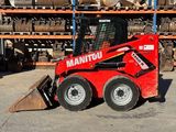 a picture of a red ski - loader parked in a warehouse