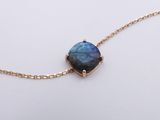 a gold chain with a blue stone on it