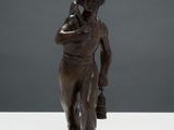 statue of a man talking on a cell phone on a white surface