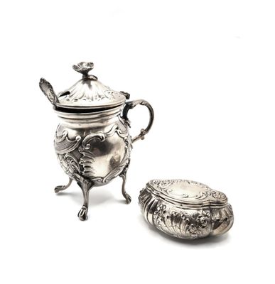 a silver teapot with a lid sitting next to a small bowl