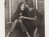 black and white photograph of a man and a woman sitting on a step