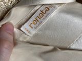 a person that is holding a dress with a label on it