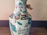 a vase that has a lamp on top of it