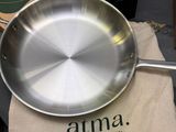 a pan sitting on a table with a bag next to it