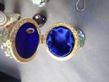 a necklace with a picture of a woman in a blue dress