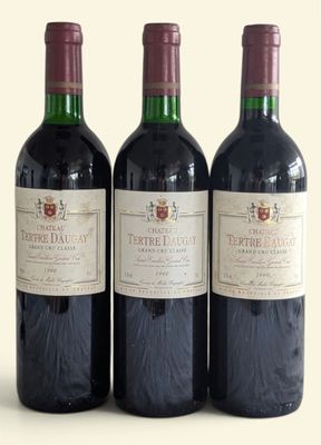 three bottles of wine sitting next to each other on a table