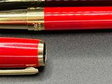 two pens that are sitting next to each other on a table