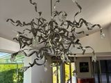 a large chandelier made out of paper streamers hanging from the ceiling