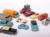 a lot of toy cars and trucks on a white surface