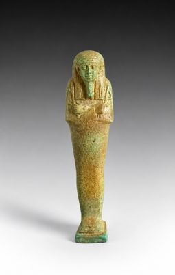 an egyptian statue of a man holding a bowl of food