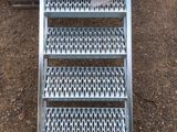 a metal ladder that is sitting on the ground