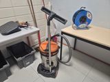 a vacuum that is sitting on the floor next to a table
