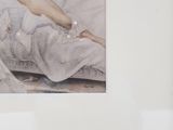 a picture of a naked woman laying on a bed