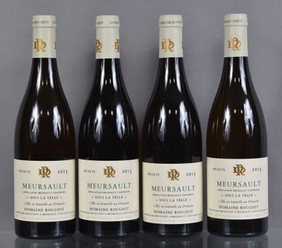 four bottles of wine are lined up on a table