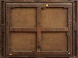 an old wooden window with a yellow button on it