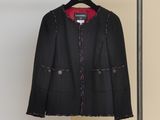jacket hanging on a hanger in a room with a white wall