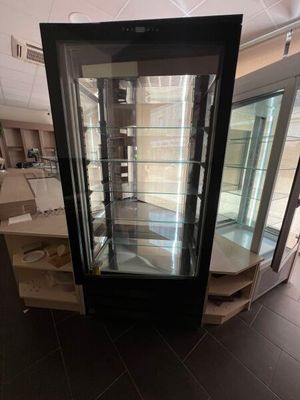 a glass display case in the middle of a room
