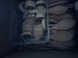 a plastic container filled with wooden spoons and spoons