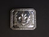une boucle de ceinture en argent ornée d'une fleur de lys