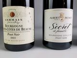 three bottles of wine that are sitting on a table