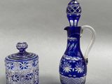 two blue glass items that are sitting on a table