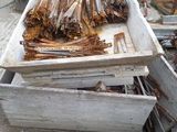 a pile of wood sitting on the ground in front of a truck
