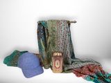 a pile of clothing and a hat on a table