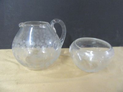 a glass pitcher and a glass bowl on a table