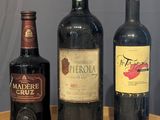 three bottles of wine sitting on a table next to each other