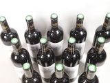 many bottles of wine that are sitting on a table