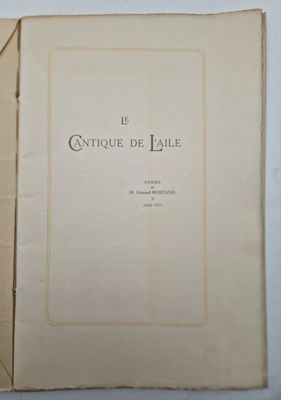 an open book sitting on top of a table next to a white wall