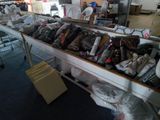 many bags of clothing on a table in a room